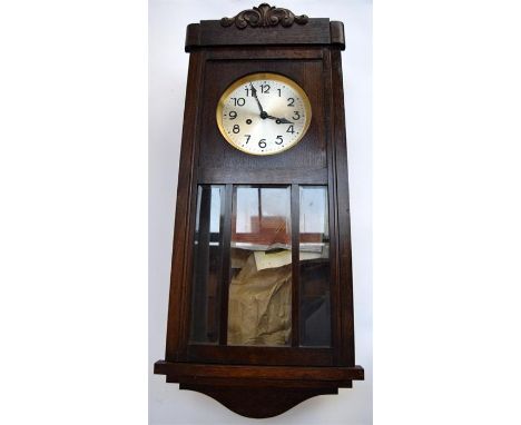 An oak cased wall clock