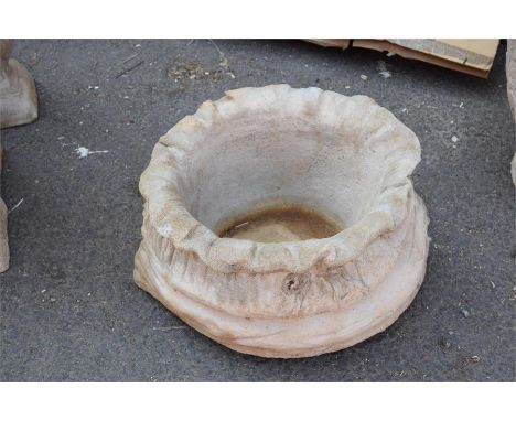 A large composite sack shaped planter