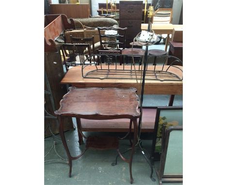 A wrought iron standard lamp on tripod base, 135cmH, and a mahogany side table with undershelf