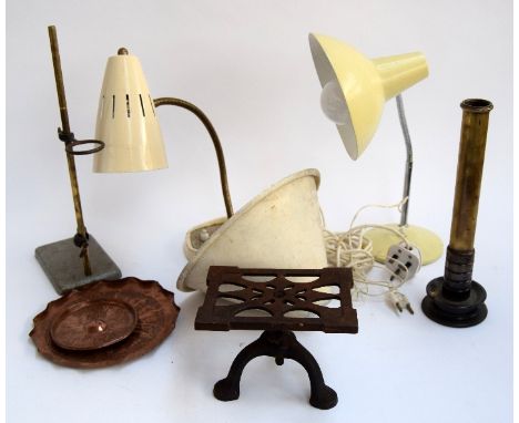 A cast iron trivet, a turned brass item, two vintage adjustable lamps, a vintage metal lampshade, and two copper plates