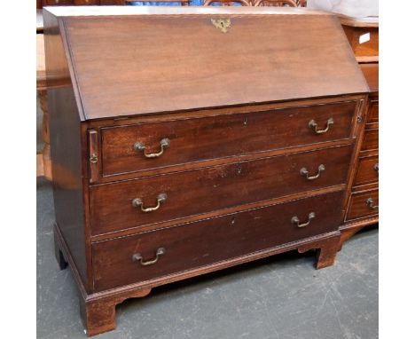 A Georgian mahogany bureau with fitted interior above three long drawers, raised on shaped bracket feet, 106.5cmW