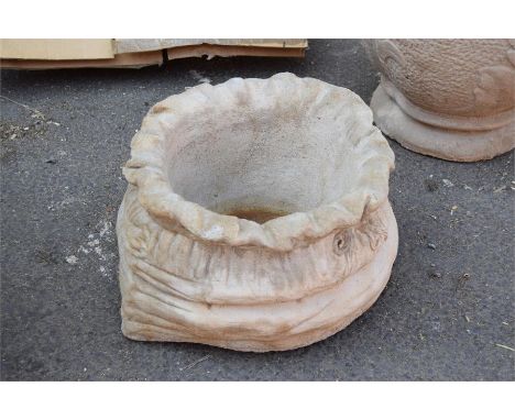 A large composite stone sack shaped planter