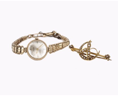 A seed pearl brooch, set with seed pearls, stamped 15ct, 4.2cm wide; and a Rotary watch, on a 9 carat gold bracelet, stamped 