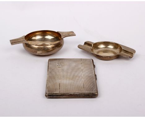 Sterling silver smoking paraphernalia to include an engine turned cigarette case and two ashtrays. 10.1oztn