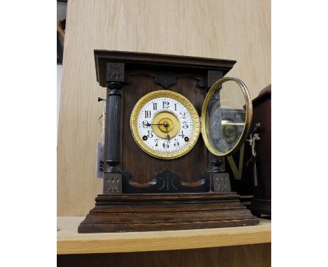 A late 19th century oak cased mantle clock by Fattorini &amp; Sons, Bradford, the enamel face with a gilt gadroon surround.