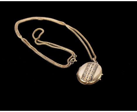 An unmarked yellow metal locket with enamel decoration on a rope twist yellow metal chain. 8g
