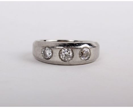 A platinum, diamond and diamond simulant ring, set with two brilliant cut diamonds and a diamond simulant, on a polished band