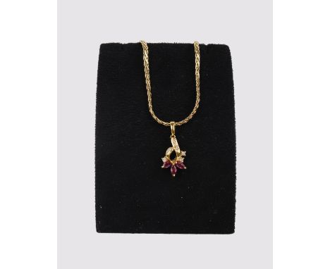 An 18ct gold ruby and diamond pendant, the three marquise cut rubies below a brilliant cut diamond set surmount, on a fancy l