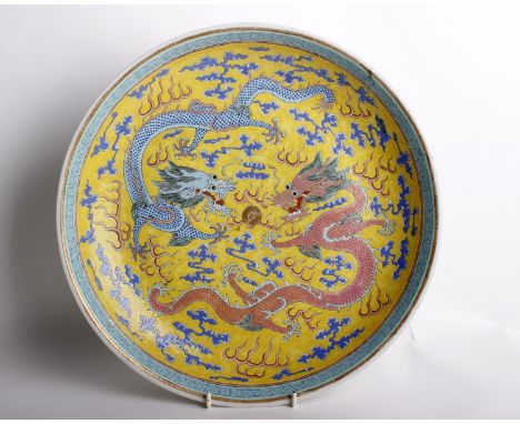 A Chinese Famille Jaune Porcelain Dragon DishHand painted in enamel in the famille jaune palette with dragons and clouds on a