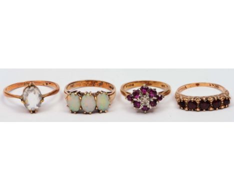 Collection of four 9ct gold rings various settings, one triple opal setting, another with garnet setting etc