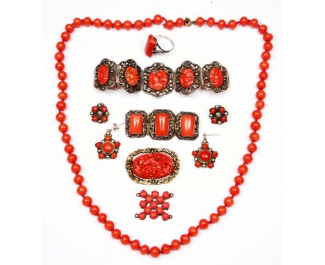 Collection of coral bead jewellery including a necklace, a carved and pierced bracelet, a Chinese bar brooch, a ring, earring