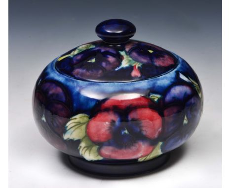 William Moorcroft (British, 1872-1945) Pansy jar and cover with WM initials and manufacturer's stamp, 10cm diameter