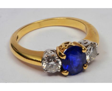 18ct Gold ring set with central and sapphire flanked by two diamonds