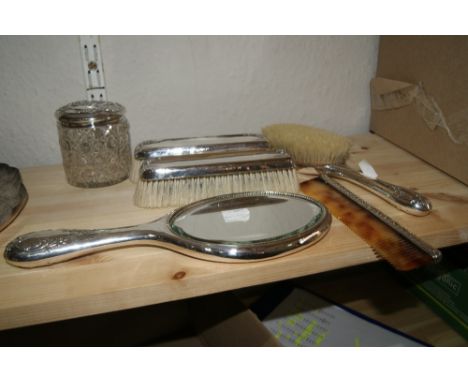 Small collection of silver mounted dressing table ware including three brushes, a hand mirror, a comb and a glass jar, all wi