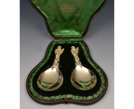 Pair of silver gilt caddy spoons of stylised form, the finials in the form of a mother and children, Edinburgh 1903