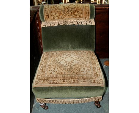 Victorian carpet upholstered low armchair with turned supports