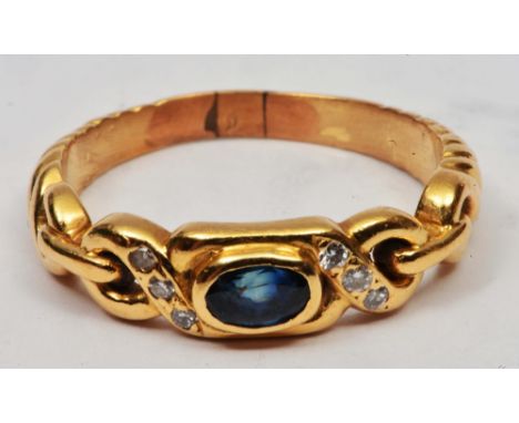 Yellow metal ring stylised sapphire and diamond setting, tests as 18ct