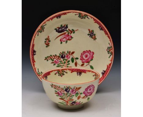 Worcester tea bowl and saucer circa 1770, decorated in polychrome enamels with Oriental flowers inside a scale pink edging, s