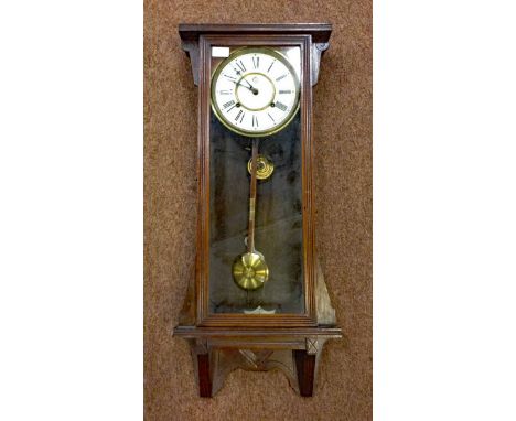 WATERBURY WALL CLOCKthe enamel face with Roman numerals, and Waterbury logo, contained in an oak case of architectural design