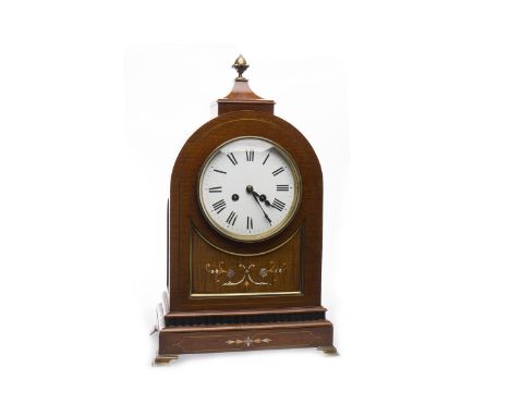 EDWARDIAN MANTLE CLOCK OF REGENCY DESIGNthe circular enamel dial with Roman numerals and eight day movement, contained in a m