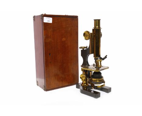 BRASS MICROSCOPEwith brass mountings and fitments, with two objective lenses, one marked 'C. Zeiss AA', the other 'R. Winkel 