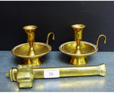 An Eastern brass pipe, together with a pair of brass chamber candlesticks, (3) 