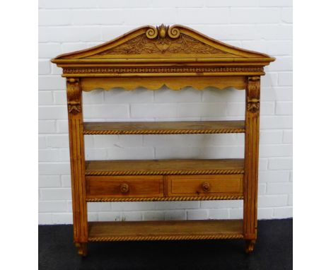Pine wall hanging open shelves with foliate carved top rail over gadroon edged shelves and two short drawers, 