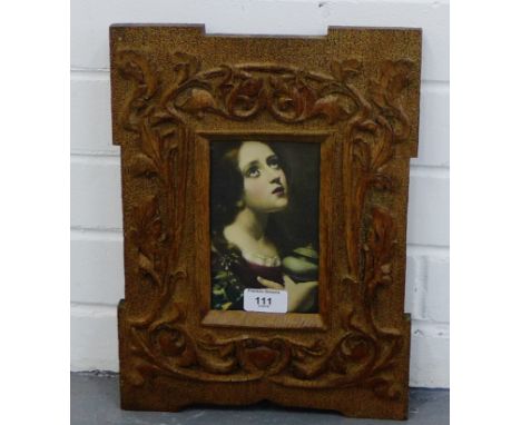 A coloured print of a 'Young Girl', contained within a carved oak Arts & Crafts style frame, 26 x 36cm overall