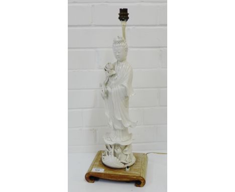 A Chinese  Blanc de Chine figure of Guanyin lamp base, on a shaped hardwood stand, height including fitting 55cm