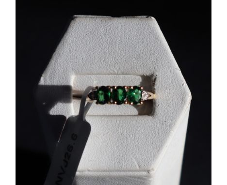 Gemporia - A 9ct gold Tsavorite Garnet and diamond ring, set with oval garnets and round cut diamonds, to a 9ct gold setting 