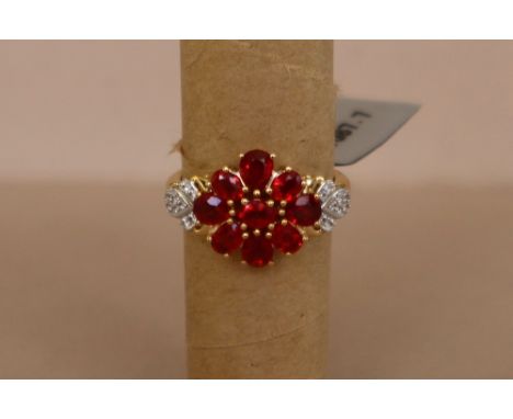 Gemporia - A 9ct gold ruby and white zircon ring, set with pear and oval cut rubies and round white zircons, to a 9ct gold se