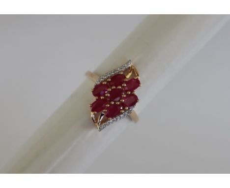 Gemporia - A 9ct ruby and white zircon ring, set with oval cut Burmese rubies and round white zircons, to a 9ct gold setting 