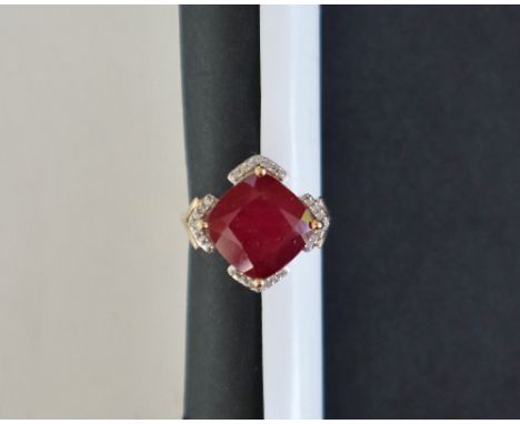 Gemporia - A 9ct gold ruby and white zircon ring, set with cushion cut Malagasy ruby and round cut white zircons, to a 9ct go