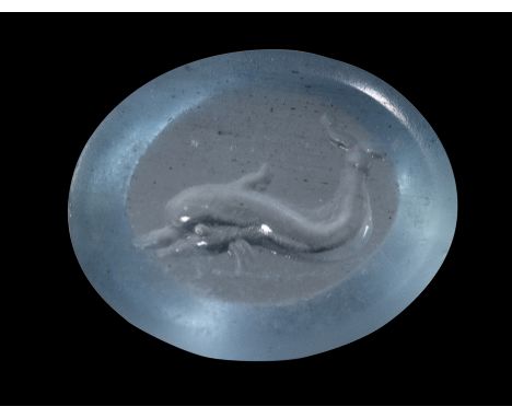 A ROMAN BERYL INTAGLIO. DOLPHIN. 1st century B.C - 1st century A.D.12 x 15 x 4,5 mmThe sea creature swims to the left. Use of