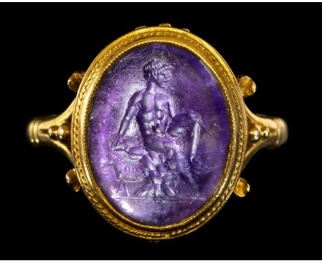 A ROMAN AMETHYST INTAGLIO SET IN A GEORGIAN GOLD RING. SEATED MERCURY. 2nd century A.D.Stone 11x16 mm; int. diam 18 mm; 7.53 