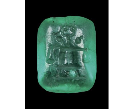 A RARE ROMAN EMERALD INTAGLIO. MODIUS EMBLEMA. Early 1st century AD.8 x 10 x 3 mmModius containing caduceus and two poppy flo