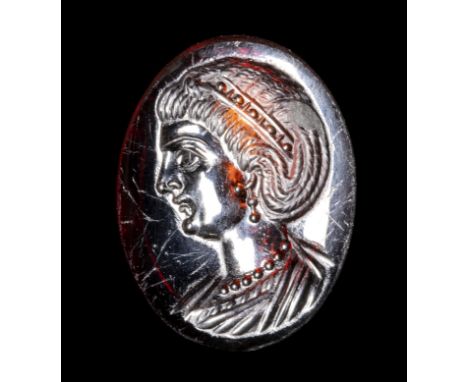 A LATE IMPERIAL ROMAN GARNET INTAGLIO. BUST OF AN EMPRESS.4th century A.D.13x17x2 mmThe portrait is facing left. She is chara