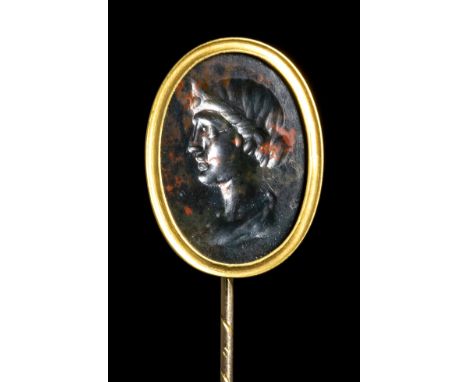 A ROMAN BLOODSTONE INTAGLIO SET IN A GOLD STICK PIN. FEMALE PORTRAIT. 2nd-3rd century A.D.Stone 12x18 mm; H max 76 mm; 4,20 g