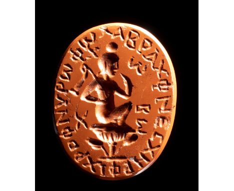 A ROMAN GNOSTIC RED JASPER INTAGLIO. SEATED HARPOCRATES ON A LOTUS WITH INSCRIPTIONS. 2nd-3rd century A.D.12x16x2 mmSeated ri