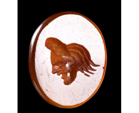 AN ITALIC CARNELIAN INTAGLIO. THEATRICAL MASK. 1st century B.C. 10x12x2 mmSmall theater mask facing left, engraved in the cen