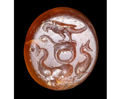 A ROMAN CARNELIAN INTAGLIO. ALLEGORICAL EMBLEMA. 1st century B.C. - 1st century A.D. 11x12x2,5 mm In the center, a ring with 