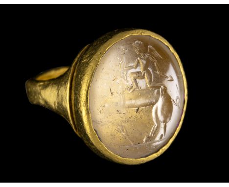 A POSTCLASSICAL ROCK CRYSTAL INTAGLIO SET IN A GOLD RING. EROS RIDING A PHALLUS. 19th - 20th century or later. Stone 14x18 mm