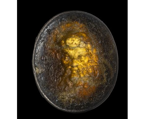 A BURNT AND CALCIFIED ROMAN CARNELIAN INTAGLIO SET IN A SILVER FRAME. MASK OF A SILENUS.1st century B.C. - 1st century A.D.12