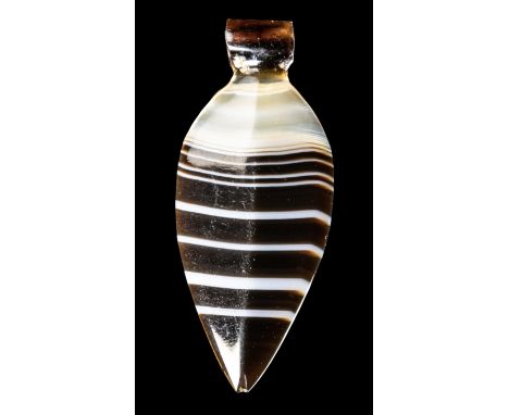 A BACTRIAN BANDED AGATE BEAD PENDANT.2nd millenium B.C.H 24 mmWith arrow shape and thin central ridge. Pierced at the base.Pr