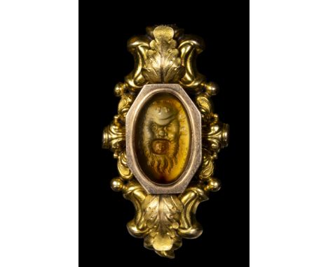 A FINE ANCIENT CARNELIAN INTAGLIO SIGNED AYLOY SET IN A GOLD BROOCH. A DIONYSIAC MASK WITH A GORGONA MASK INSIDE THE MOUTH. E