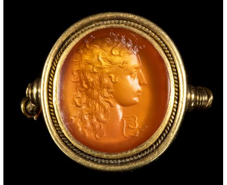 A FINE CARNELIAN INTAGLIO SET IN A GOLD RING. BUST OF MEDUSA. 18th centuryStone 15x16 mm; Int. Size 16,5x19 mm; 8,54 grThe re