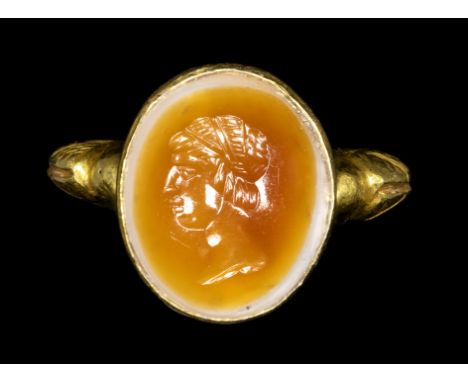 A ROMAN AGATE INTAGLIO SET IN A REVIVAL BYZANTINE GOLD RING. MALE PORTRAIT.2nd - 3rd century A.D.Stone 11x13 mm; int. diam. 1