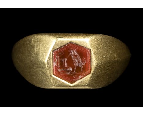 A ROMAN CARNELIAN INTAGLIO SET IN A MODERN GOLD RING. ROOSTER HUNTING A SNAKE ON A VASE. 1st-2nd century A.D.Stone 6x7 mm; in