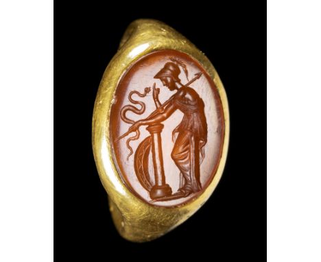 A LARGE ROMAN GOLD RING SET WITH A CARNELIAN INTAGLIO. ATHENA WITH HER WEAPONS AND A SNAKE. 2nd-1st century B.C.Stone 13x18 m