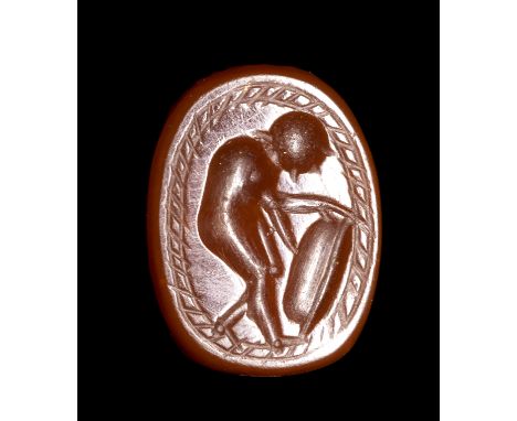AN ETRUSCAN CARNELIAN SCARAB. WARRIOR. 3rd century B.C.8x11x5 mmThe warrior is facing right, holding a shield. Globular eleme